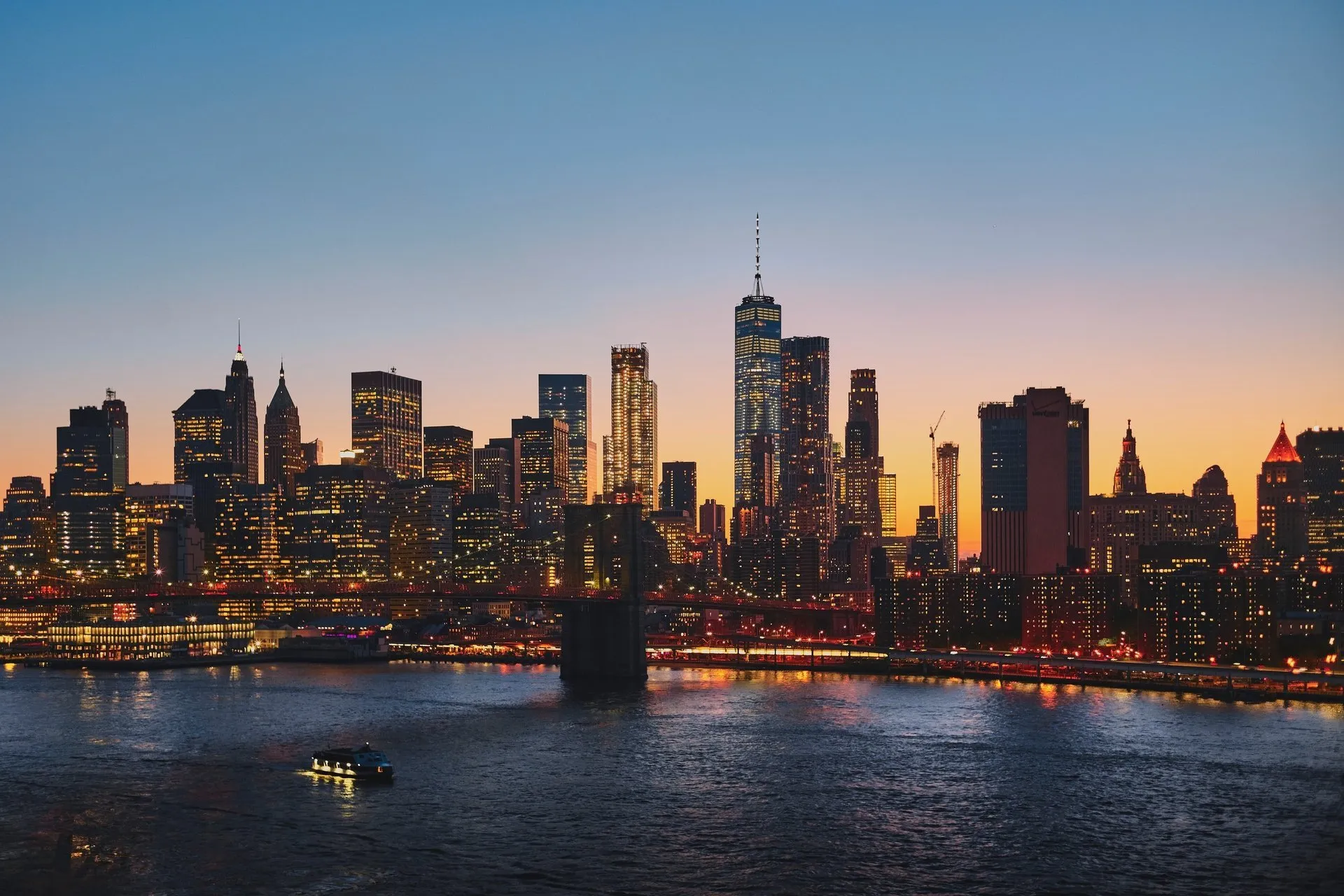 The New York skyline across the harbor at sunset
